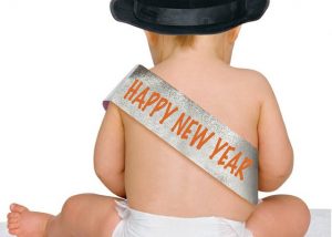 baby wearing happy new year sash
