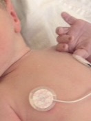 baby with heart rate monitor on