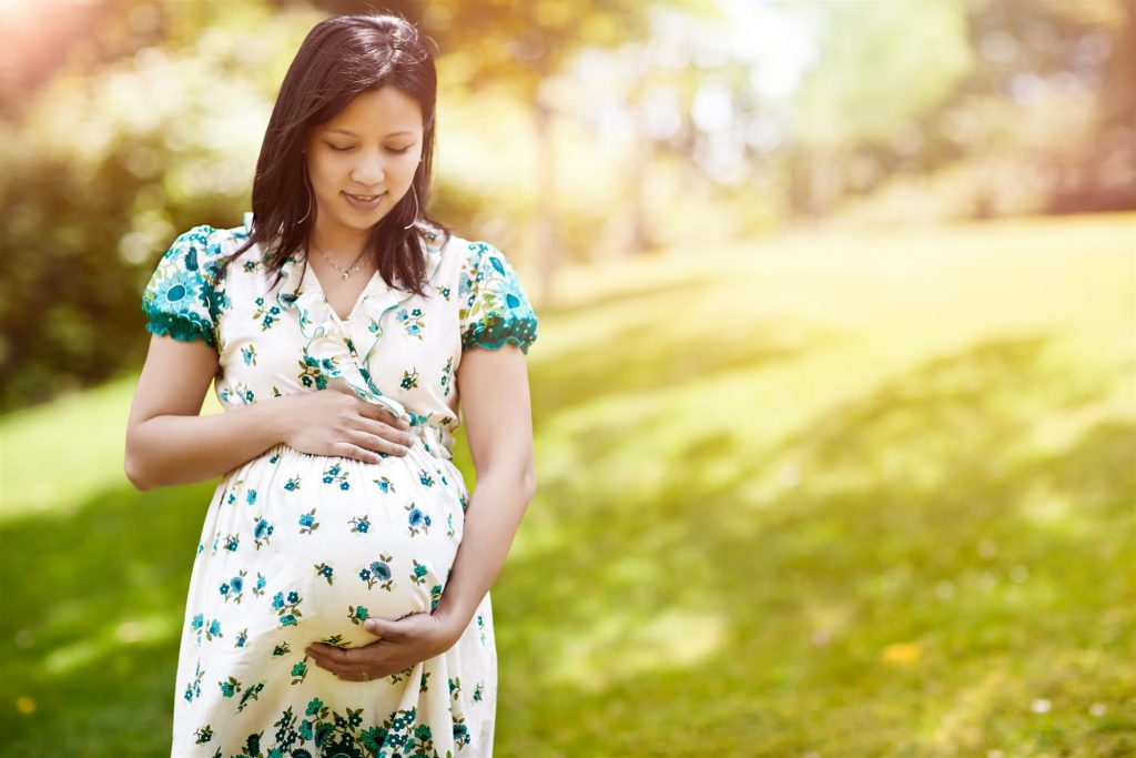 pregnant surrogate holding her stomach