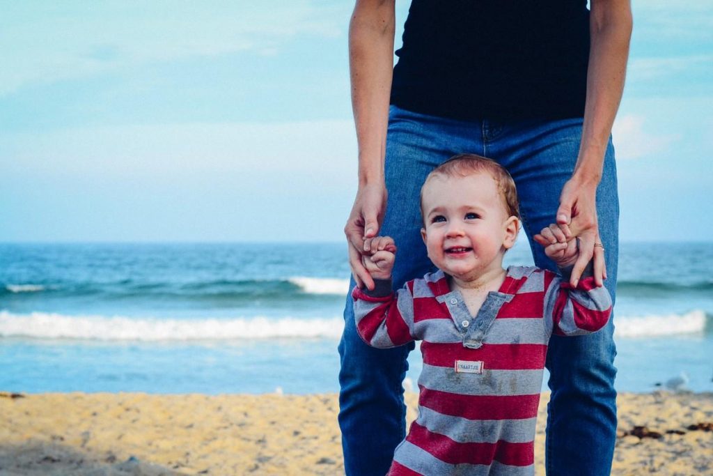 father and son at beach holding hands