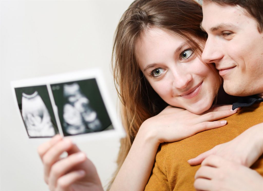 beautiful couple watching ultrasound pictures
