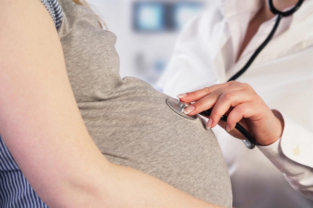doctor examining a pregnant woman
