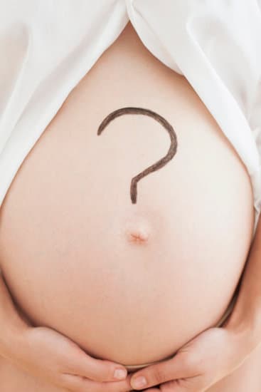 Pregnant woman with a question mark on her stomach. 